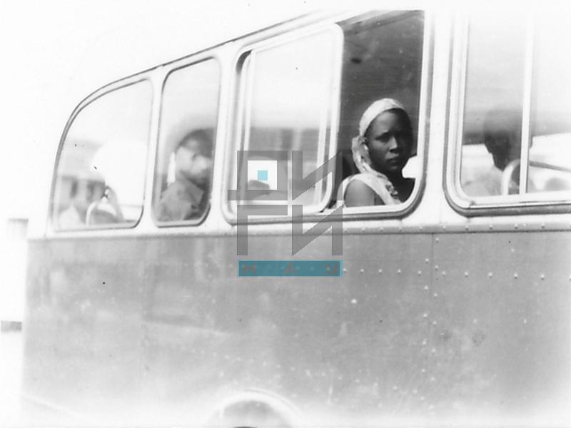 A Woman Looking through the Window of a Bus (VZP.N.191-23)